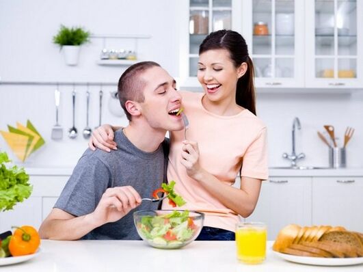The girl feeds her man with products to increase potency. 